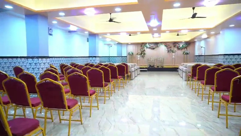 Wedding video frame showing central aisle and stage setup